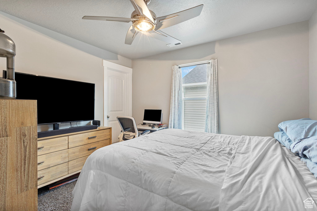 Bedroom featuring visible vents, ceiling fan, and a textured ceiling