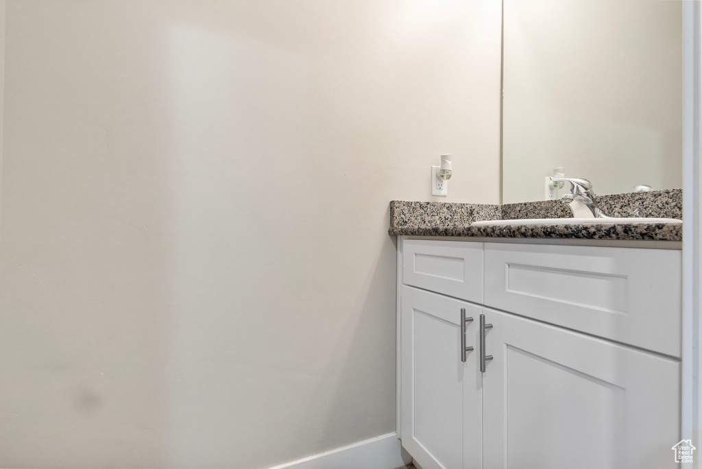 Bathroom with vanity and baseboards