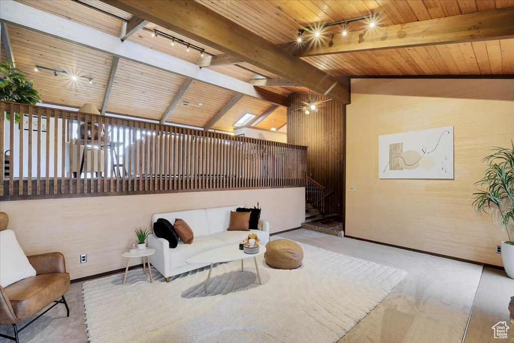 Living room featuring wooden ceiling, vaulted ceiling with beams, and track lighting