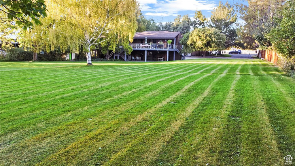 View of yard with a wooden deck