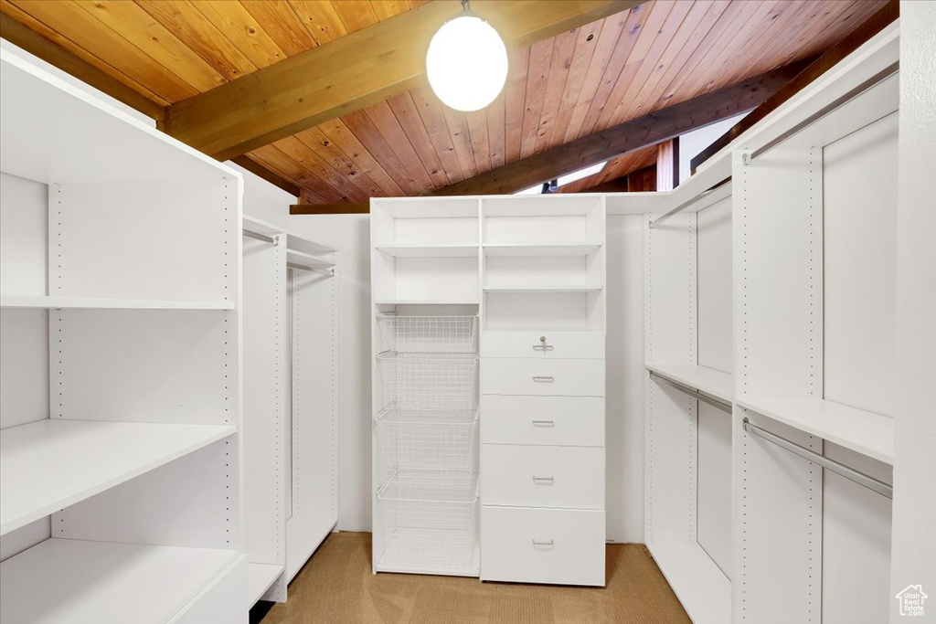 Spacious closet featuring beam ceiling