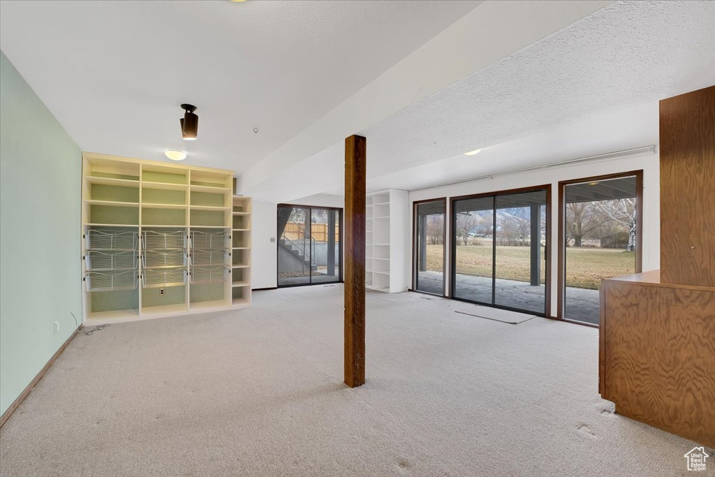 Empty room featuring carpet floors and a textured ceiling