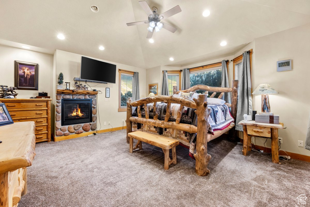 Bedroom with carpet floors, a fireplace, recessed lighting, vaulted ceiling, and a ceiling fan