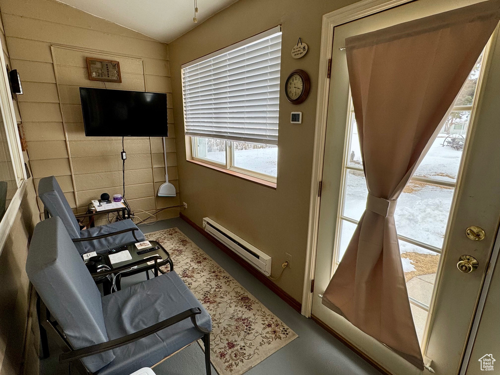 Sitting room with baseboards, vaulted ceiling, and baseboard heating