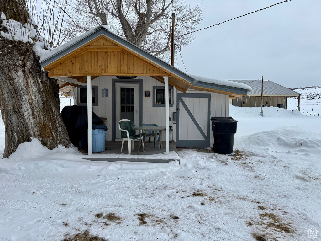 View of front of property featuring a shed