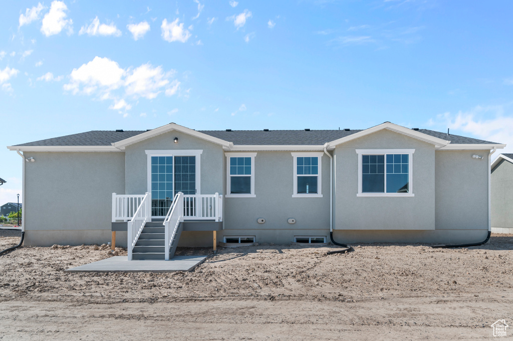 Back of house featuring stucco siding