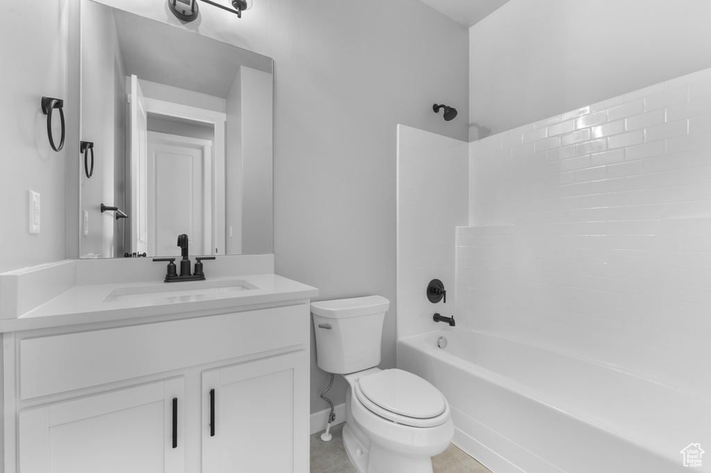 Bathroom featuring toilet, vanity, and  shower combination