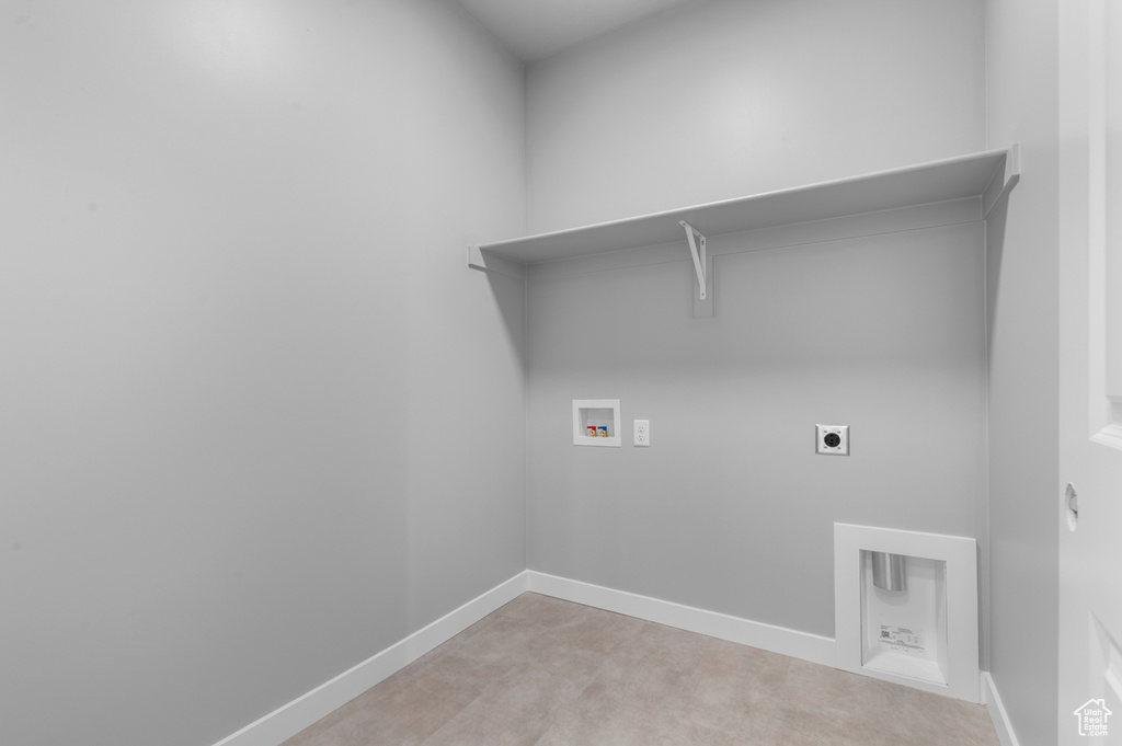 Laundry area with hookup for a washing machine, hookup for an electric dryer, and baseboards