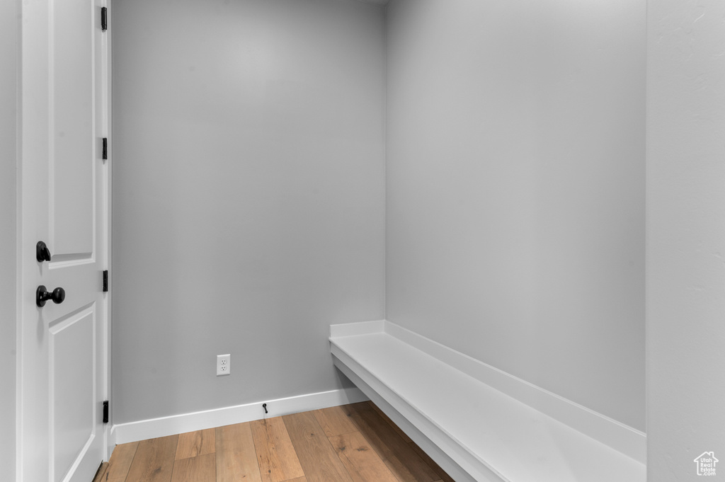 Mudroom featuring light wood-type flooring and baseboards