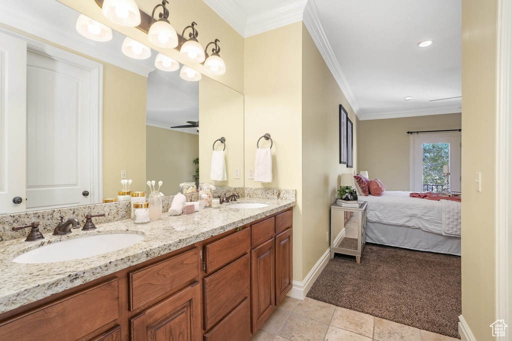 Full bathroom featuring baseboards, ensuite bath, ornamental molding, and a sink