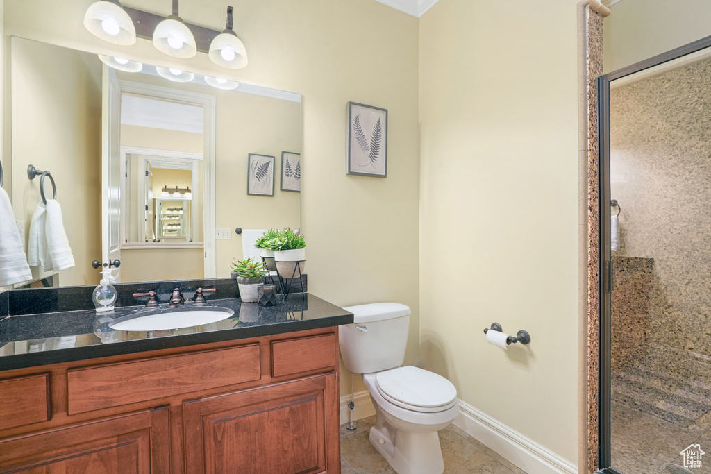 Full bathroom with a stall shower, baseboards, toilet, tile patterned floors, and vanity