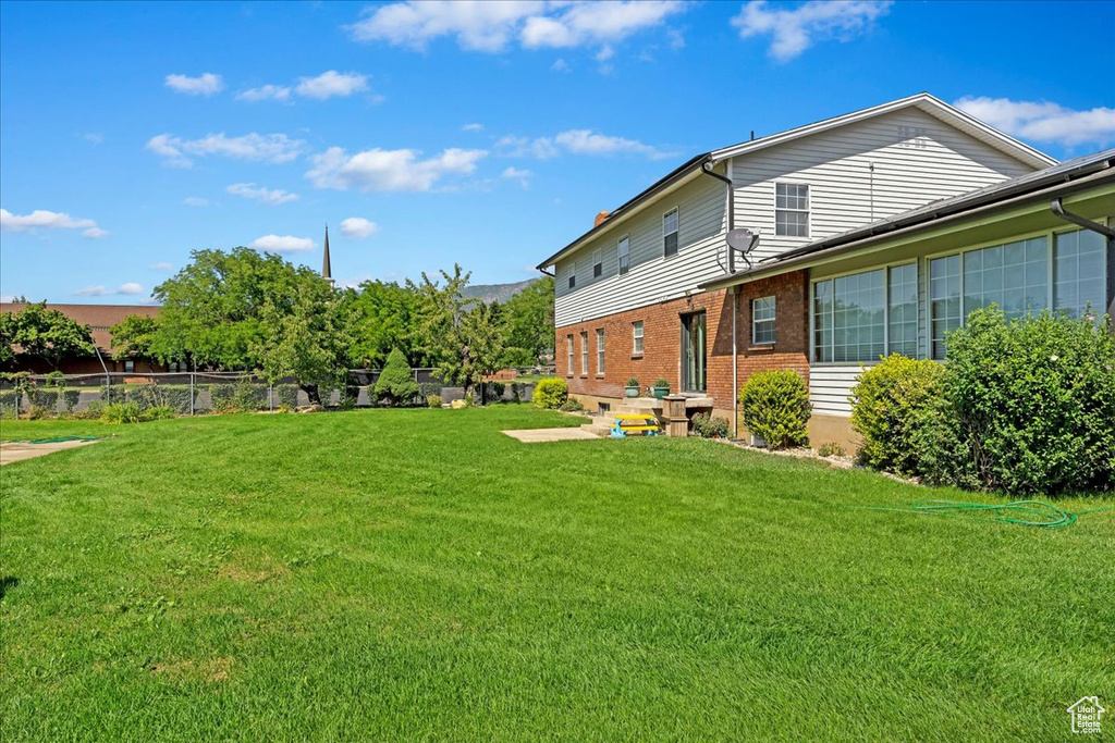 View of yard featuring fence