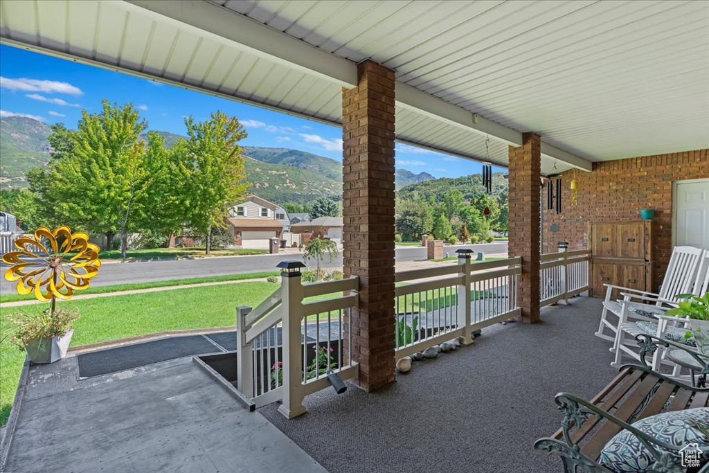 View of patio featuring a porch and a mountain view