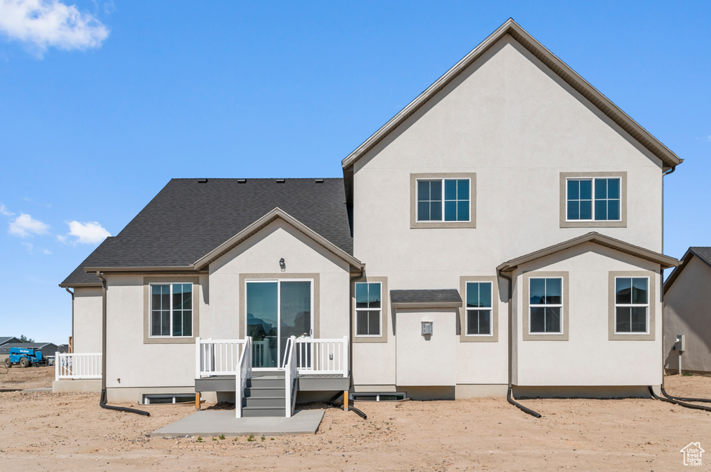 Back of house featuring stucco siding