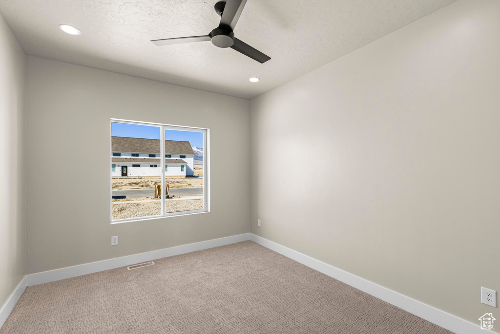 Spare room with visible vents, baseboards, a ceiling fan, light colored carpet, and recessed lighting
