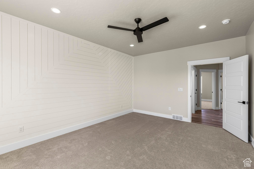 Empty room with recessed lighting, visible vents, a ceiling fan, carpet flooring, and baseboards
