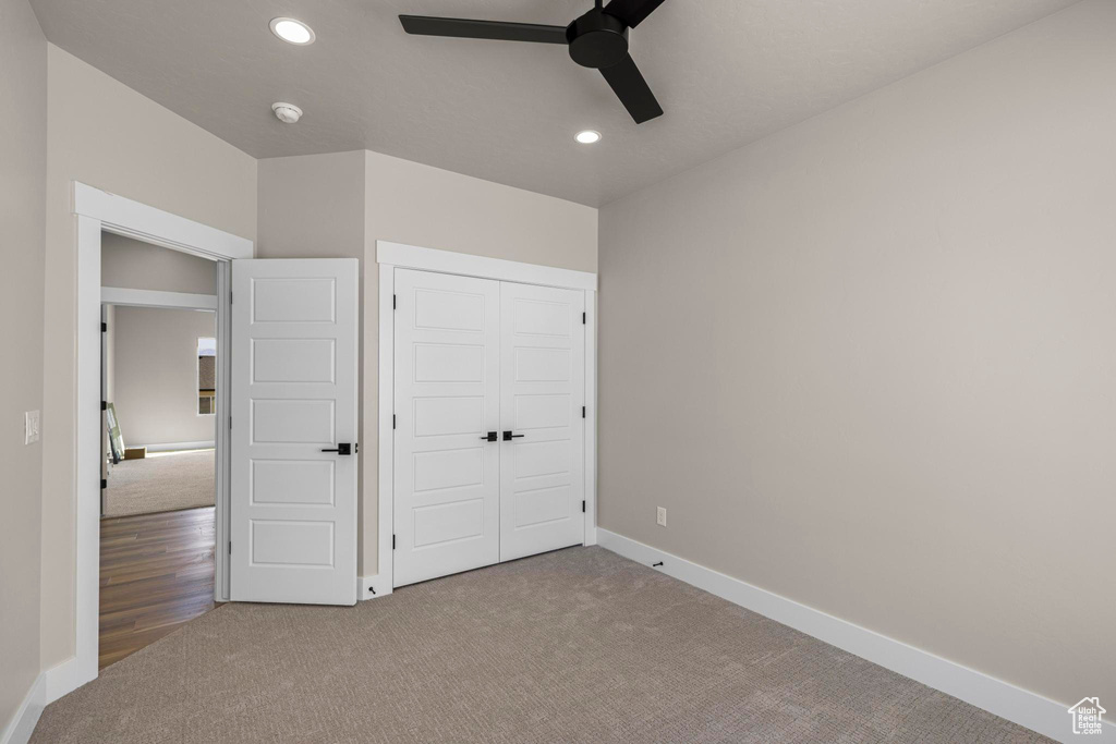 Unfurnished bedroom with carpet, baseboards, a closet, and recessed lighting