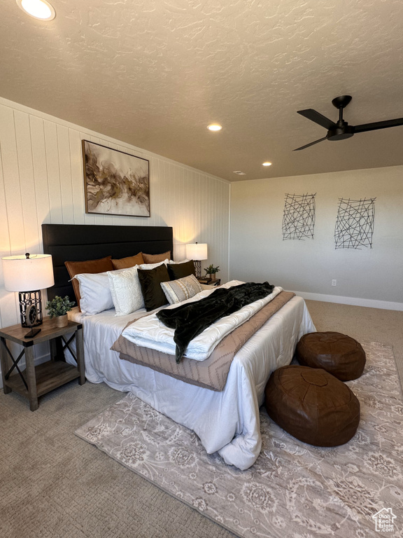 Bedroom with carpet floors, a textured ceiling, recessed lighting, and a ceiling fan