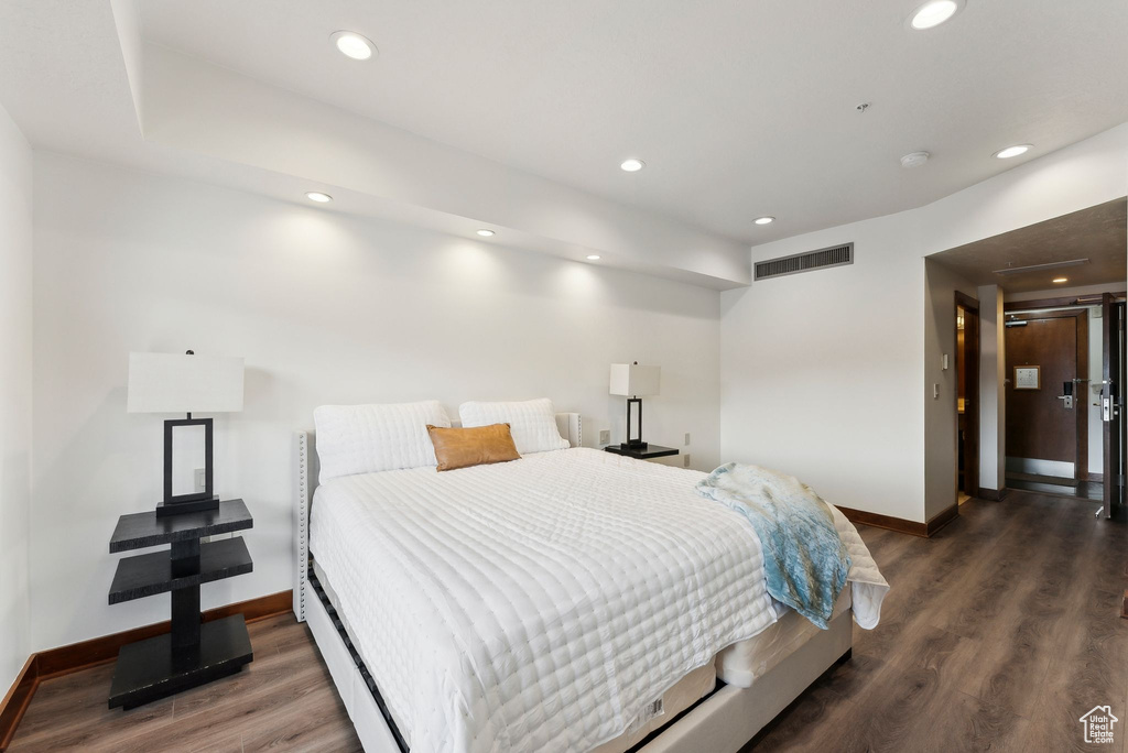 Bedroom featuring baseboards, wood finished floors, and recessed lighting