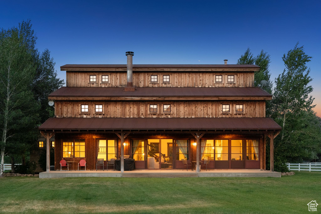 Back of house featuring a metal roof