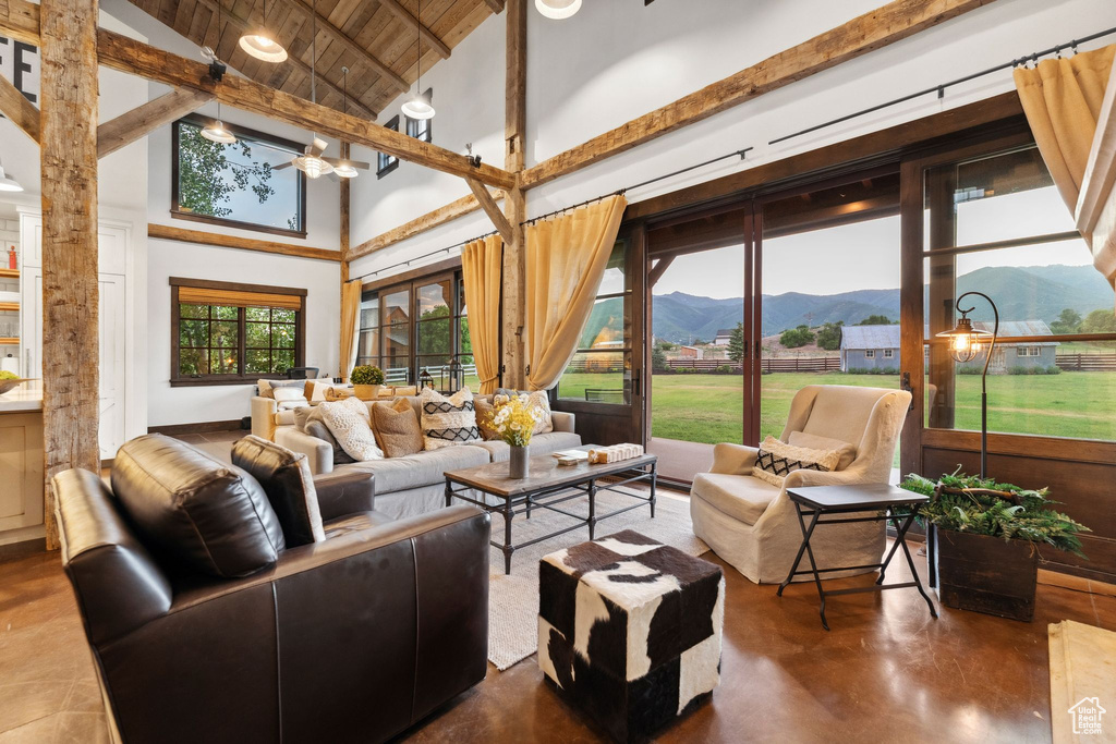 Sunroom featuring a mountain view and a chandelier