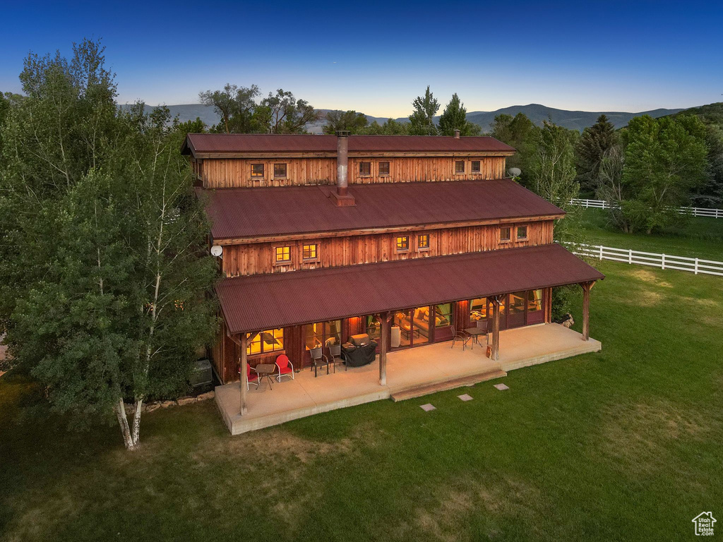 Back of property featuring a patio area and a mountain view