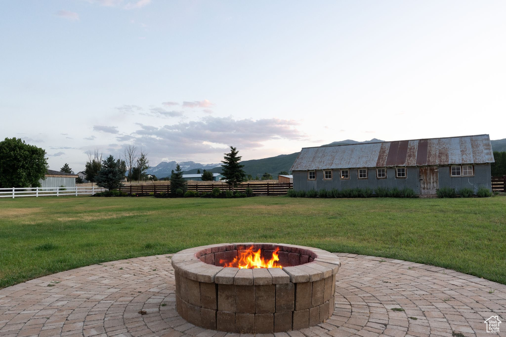 View of patio with a fire pit and a mountain view
