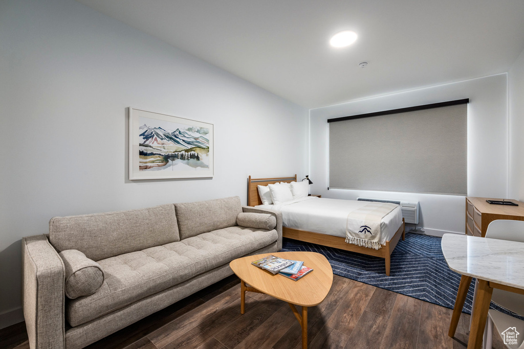 Bedroom with hardwood / wood-style flooring and vaulted ceiling