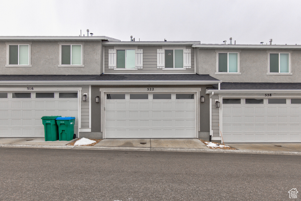Exterior space featuring a garage and stucco siding