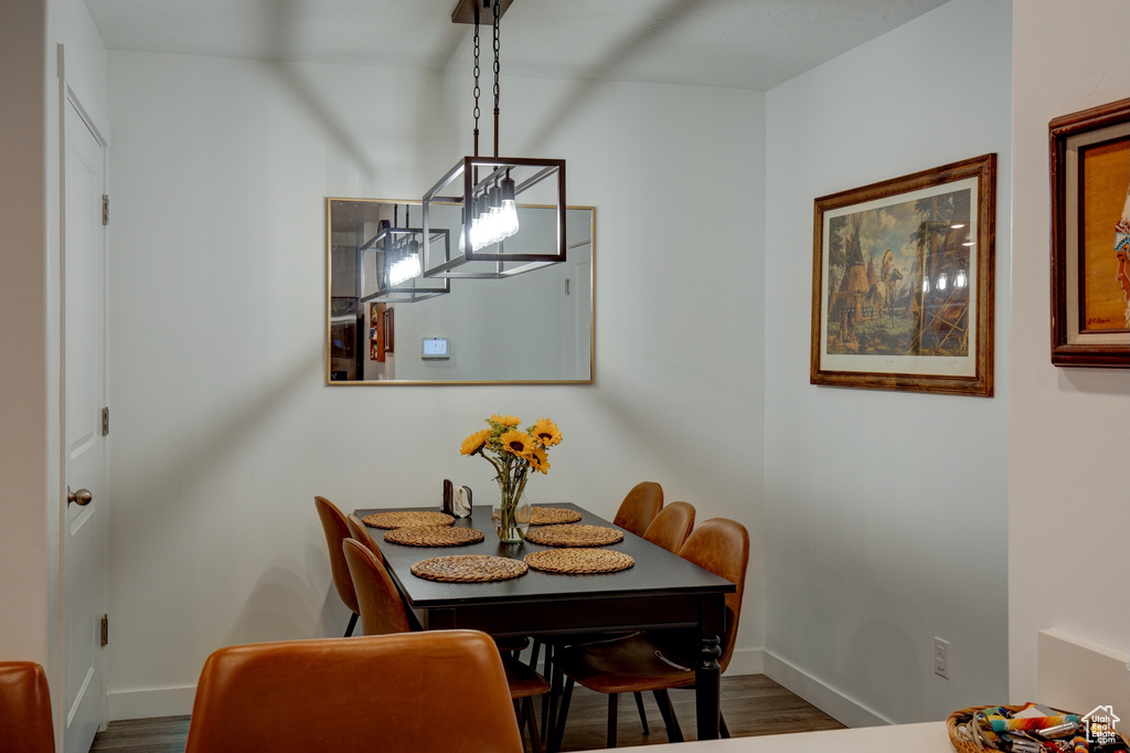 Dining area with baseboards and wood finished floors