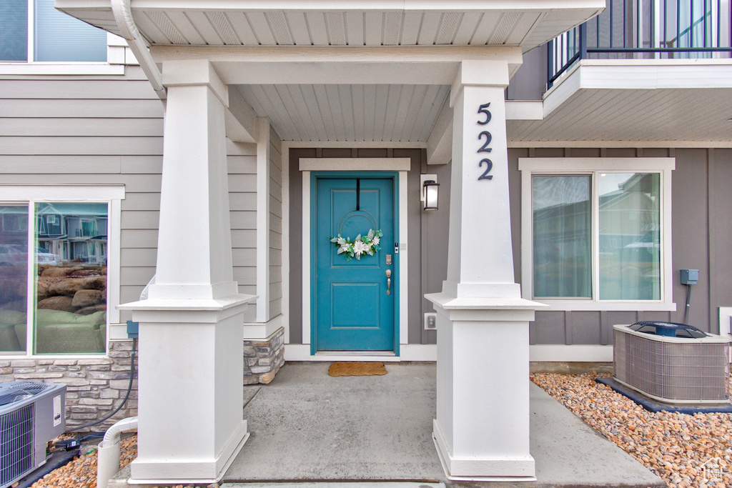 Property entrance with central AC and stone siding