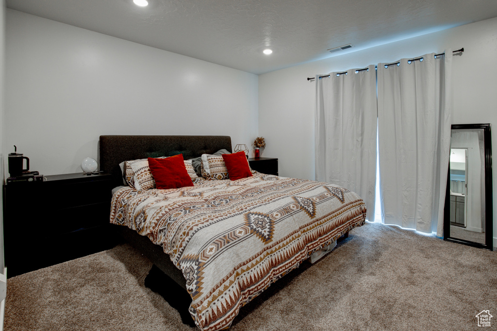 Bedroom featuring carpet flooring, visible vents, and recessed lighting