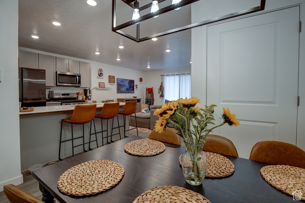 Dining space featuring light wood-style flooring and recessed lighting