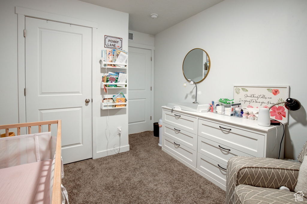 Bedroom featuring light carpet, baseboards, and visible vents