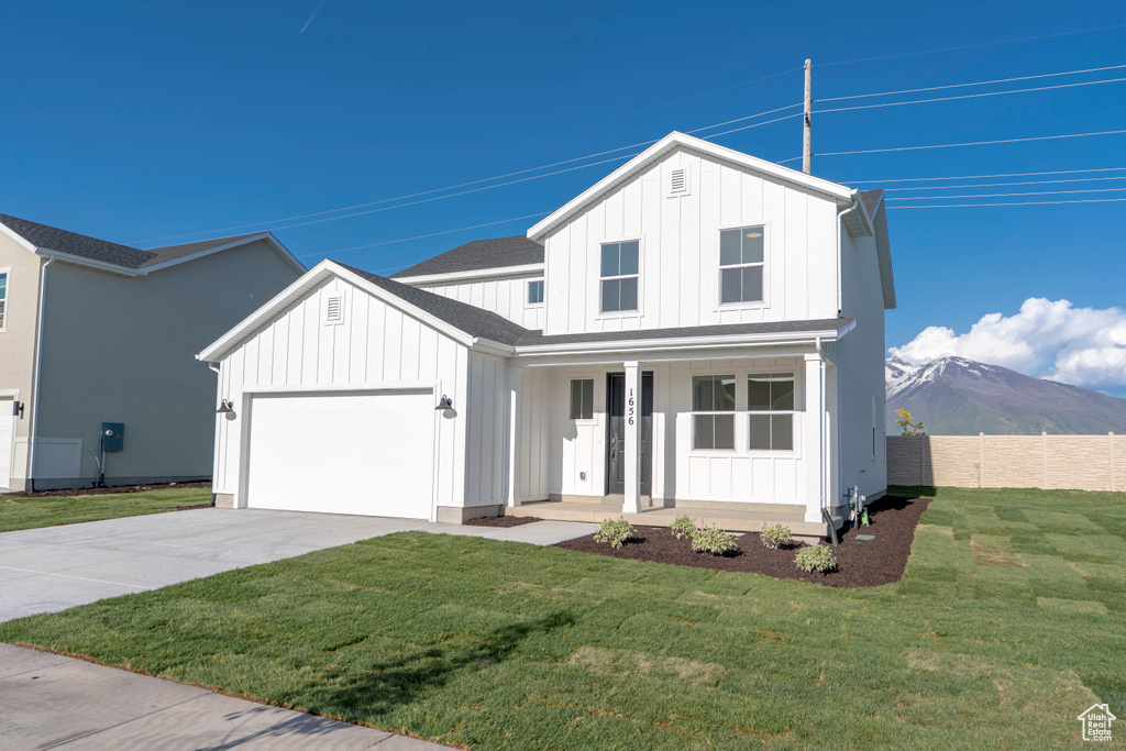 Modern inspired farmhouse with board and batten siding, a porch, concrete driveway, and a garage