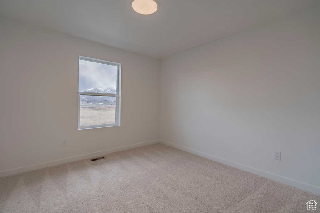 Spare room with carpet flooring and baseboards