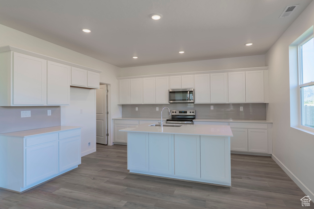 Kitchen with appliances with stainless steel finishes, plenty of natural light, light countertops, backsplash, and recessed lighting
