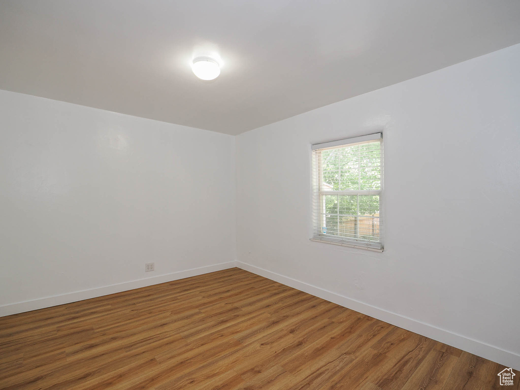 Empty room featuring baseboards and wood finished floors