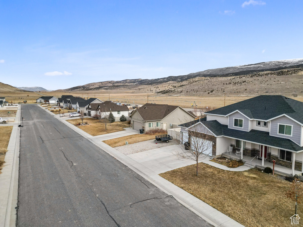 View of street with a residential view, a mountain view, and curbs