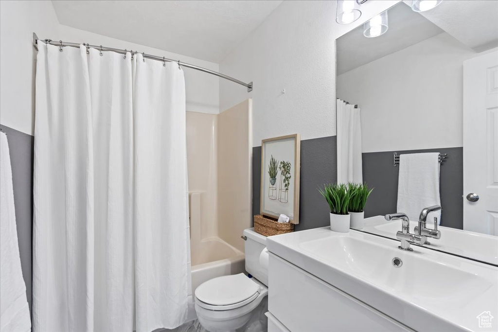 Full bath with toilet, shower / tub combo, and vanity