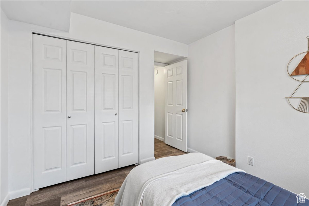 Bedroom featuring a closet and dark wood finished floors