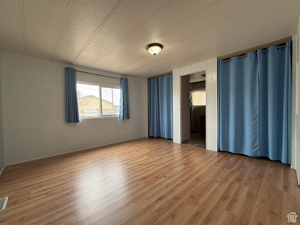 Unfurnished bedroom featuring light wood-type flooring and visible vents