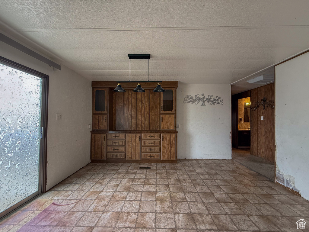 Interior space with a textured ceiling and stone finish flooring