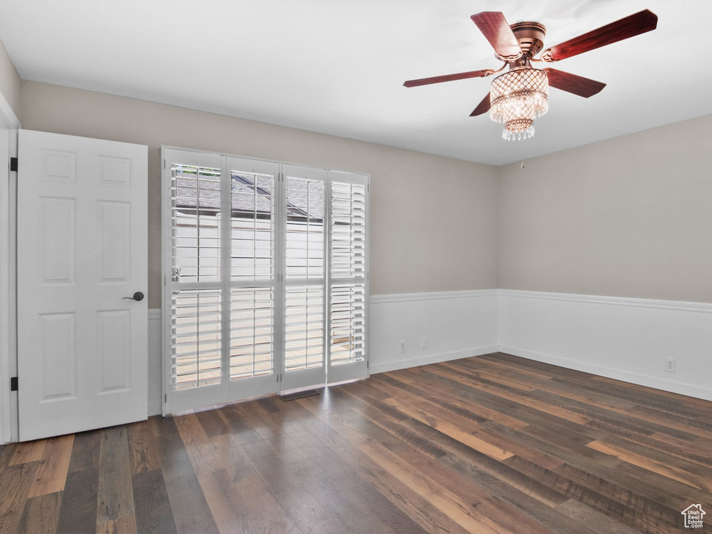 Spare room featuring wood finished floors and a ceiling fan