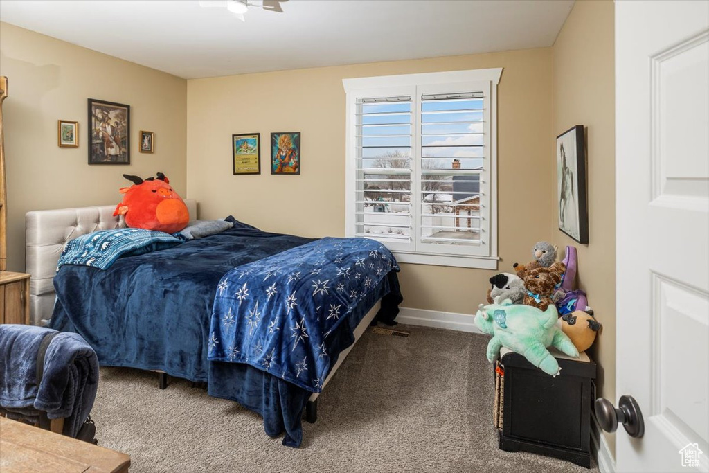 Bedroom featuring carpet floors and baseboards
