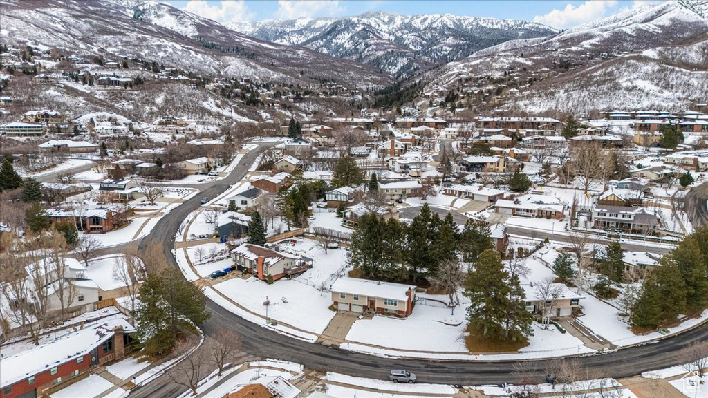 Snowy aerial view with a residential view and a mountain view