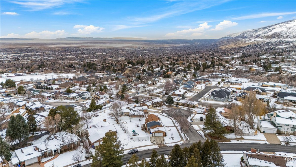 Snowy aerial view with a residential view and a mountain view