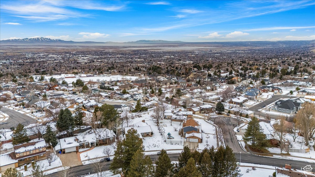 Snowy aerial view with a residential view and a mountain view