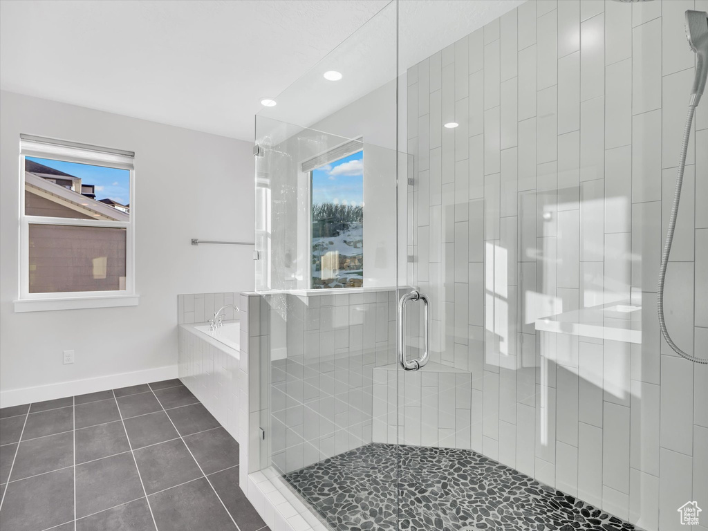 Bathroom with a garden tub, baseboards, a shower stall, and tile patterned floors