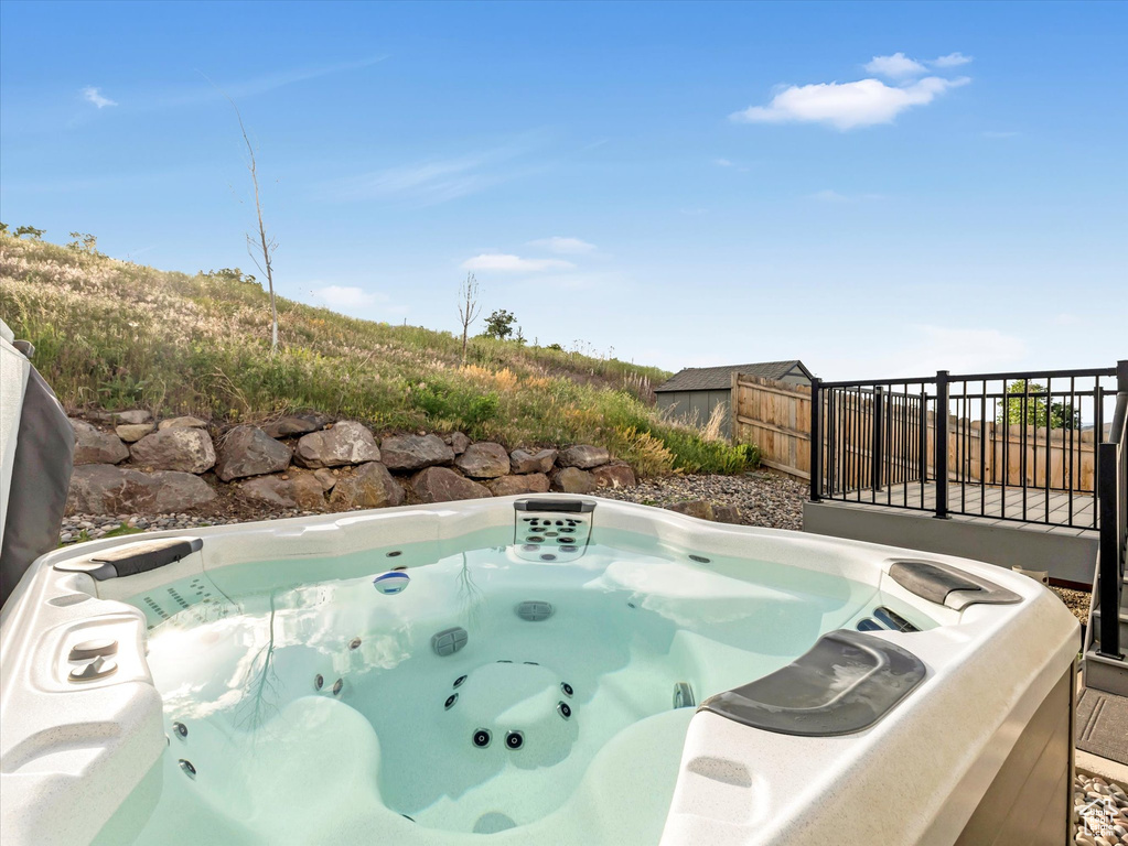 View of swimming pool featuring a hot tub